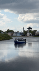 Tour boat carries passengers past cathedral in Vologda