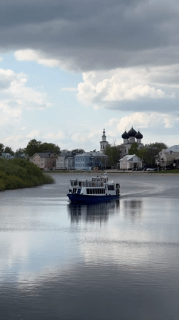 Tour boat carries passengers past cathedral in Vologda
