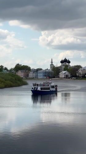 Tour boat carries passengers past cathedral in Vologda