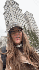Woman films outdoors in residential Novosibirsk on overcast morning