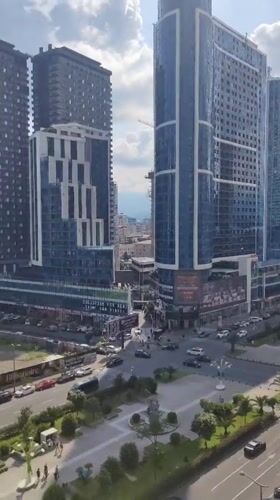 Batumi's modern coastline and skyline, seen from street and window