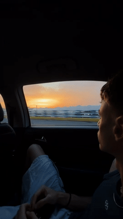 Young man observed as passenger in moving car, Liangjiang