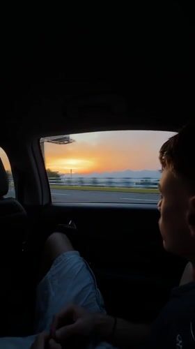 Young man observed as passenger in moving car, Liangjiang
