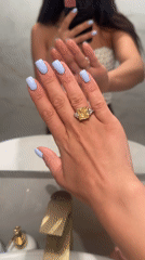 Woman displays yellow diamond ring in Khimki bathroom mirror