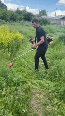 Man operates string trimmer in Gyumri, Armenia