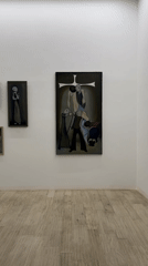 Gallery visitor documents religious artwork and oil paintings in Tbilisi