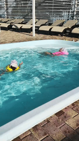 Kids and adults enjoying a sunny outdoor pool afternoon