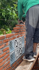 Brick construction underway, with a guava tree and sun halo nearby