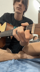 Young musician spends morning practicing guitar around Đà Nẵng apartment