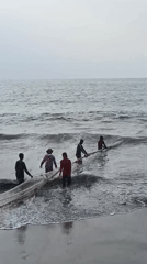 Fishing crews haul nets and sort catch on Pangandaran beach