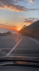 Driver captures sunset over sea from Montenegro highway