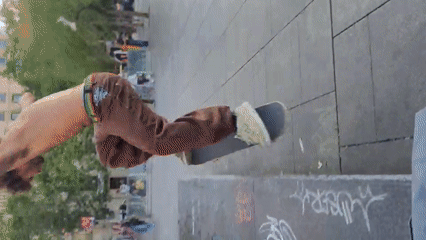 Skateboarder practices tricks in Barcelona public square during evening
