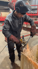 Worker grinds metal object in Montenegro workshop
