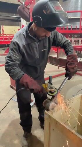 Worker grinds metal object in Montenegro workshop