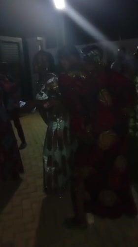 Three women dance together under lights in Tsaunin Kura