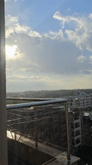 Rainy cityscape captured from elevated balcony view
