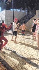 Costume characters and dancing at an outdoor party in Vahdat