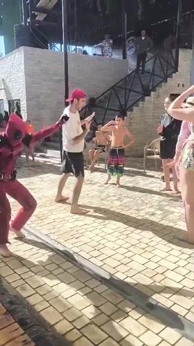 Costume characters and dancing at an outdoor party in Vahdat