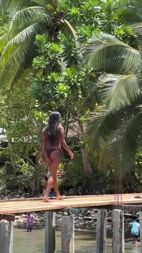Tourists enjoy rope swings and swimming in Dapa Philippines