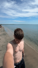 Man takes beach selfies in Burgas, Bulgaria morning