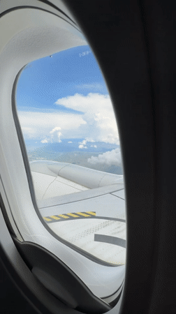 Passenger films airplane wing with arrow markings over Tbilisi