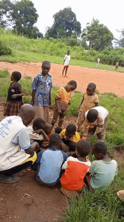 Adult leads educational activities with children in rural Congo villages