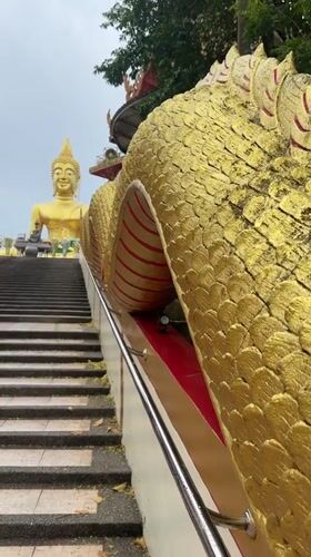 Golden Buddha statue and ornate stairway documented in Pattaya