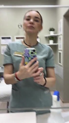 Healthcare worker Anna takes selfies at medical facility