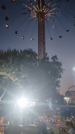 Star Flyer swings spin at dusk in an amusement park setting