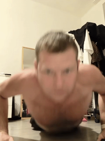 Man performs push-ups in Prague bedroom