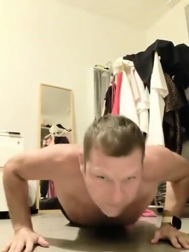 Man performs push-ups in Prague bedroom