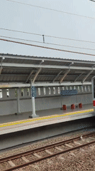 KAI train activity at Telagamurni station on a quiet weekday morning