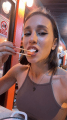 Couple shares Thai dinner at outdoor restaurant near nightlife district