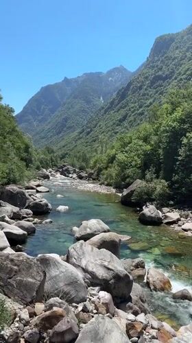Crystal-clear Verzasca River flowing through its iconic rocky gorge