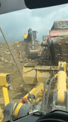 Construction worker films soil screener from machinery cabin in Bulgaria