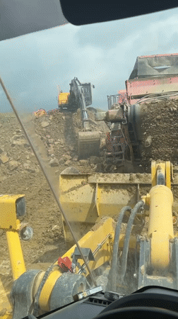 Construction worker films soil screener from machinery cabin in Bulgaria