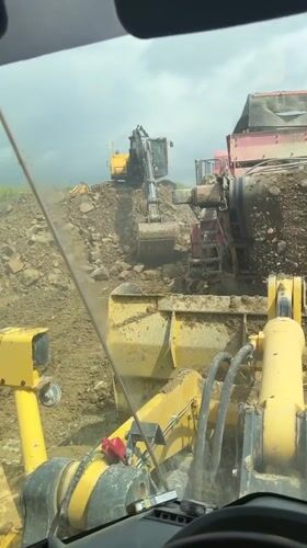 Construction worker films soil screener from machinery cabin in Bulgaria