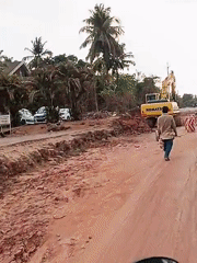 Road construction underway in Britona with excavator and worker