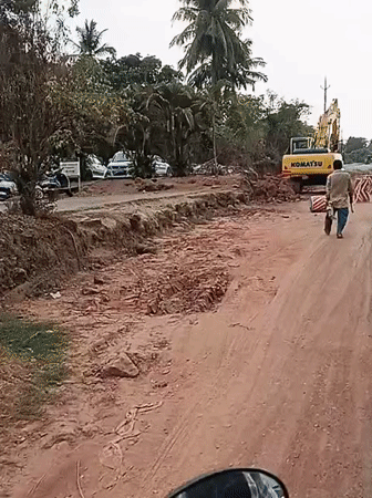 Road construction underway in Britona with excavator and worker