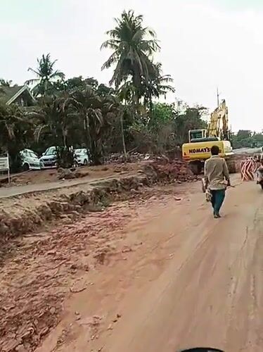 Road construction underway in Britona with excavator and worker