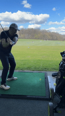 Man practices golf swing at Luxembourg driving range