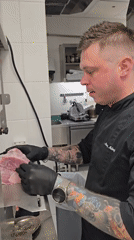 Chef prepares cheeseburgers in Montenegro commercial kitchen