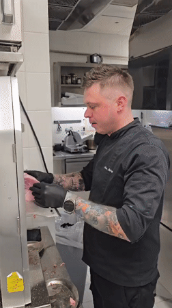 Chef prepares cheeseburgers in Montenegro commercial kitchen