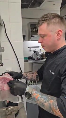 Chef prepares cheeseburgers in Montenegro commercial kitchen