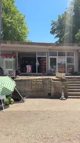 This media file appears to be a collection of short video clips, likely taken in and around Osmaniye, Turkey. The clips depict everyday scenes with a focus on rural or semi-rural settings, suggesting a local ambiance.

The first clip shows a market stall laden with fresh produce, including tomatoes, cherries, and other fruits and vegetables. A person, likely a vendor, is seated behind the stall, tending to their wares. The scene suggests a sunny day, with ample natural light illuminating the vibrant colors of the produce.

The subsequent clips shift to road scenes. One shows a red car parked by the side of a road, with a person on a motorcycle passing by. Another clip provides a view from inside a white vehicle, capturing the side of a white car in motion and a white truck in the distance on a tree-lined road. The presence of utility poles and the natural foliage indicate an outdoor environment, possibly a countryside road or a less urbanized area. The weather appears to be fair, with clear skies visible in some shots.

While no explicit text is visible in the clips, the visual cues of a market, vehicles, and natural landscapes in what is identified as Osmaniye, Turkey, collectively paint a picture of daily life in that region. The overall tone is casual and observational, capturing simple moments of activity and scenery.
