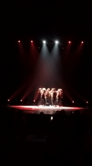 Synchronized dance group performs under colored spotlights in Saint Petersburg