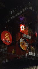 Night out in a Vietnamese city's lit-up hospitality strip