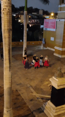Traditional folk dancers perform in colorful dress at dusk, Barranco