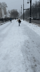Pedestrian slips on icy sidewalk during snowfall in Perm