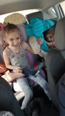 Mother records video with laughing children in car